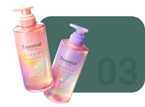 Two bottles of Essential Barrier Shampoo with gradient colors on a white background.